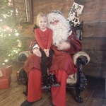 Z wizytą u świętego Mikołaja - dziewczynka z Mikołajem