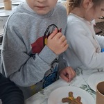 Jarmark Bożonarodzeniowy - dziecko dekoruje pierniczki