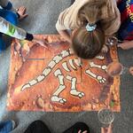 W świecie dinozaurów- dzieci układają szkielet dinozaura