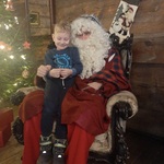 Z wizytą u świętego Mikołaja - dziecko z Mikołajem